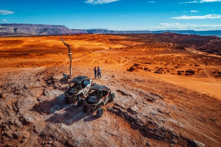 a man riding a motorcycle down a dirt road