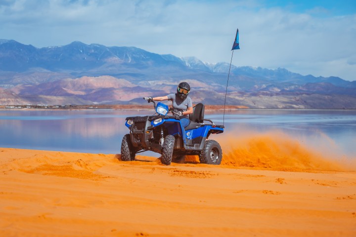 a man riding on the back of a boat in a body of water