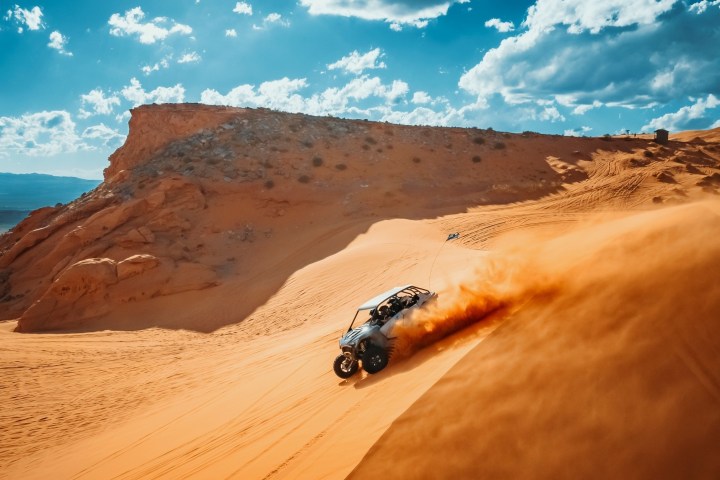 a man riding a motorcycle on the side of a mountain