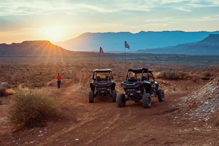 a motorcycle is parked in the dirt with a mountain in the desert